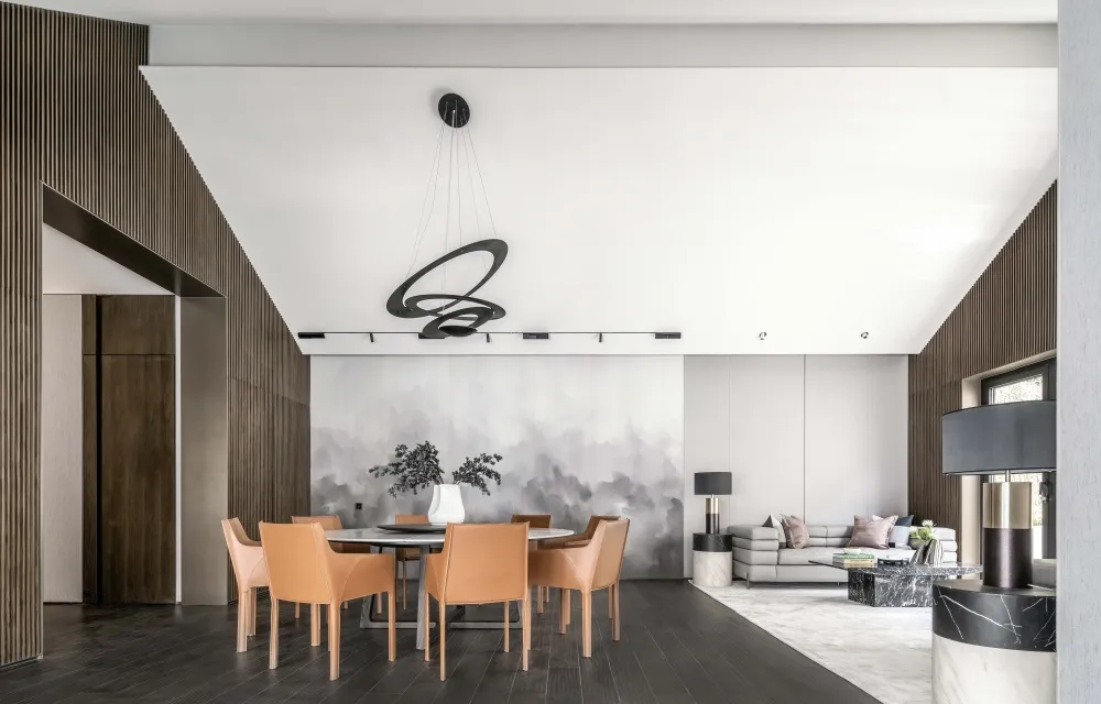 Modern living and dining room with minimalist decor, hardwood floors, and contemporary furniture.