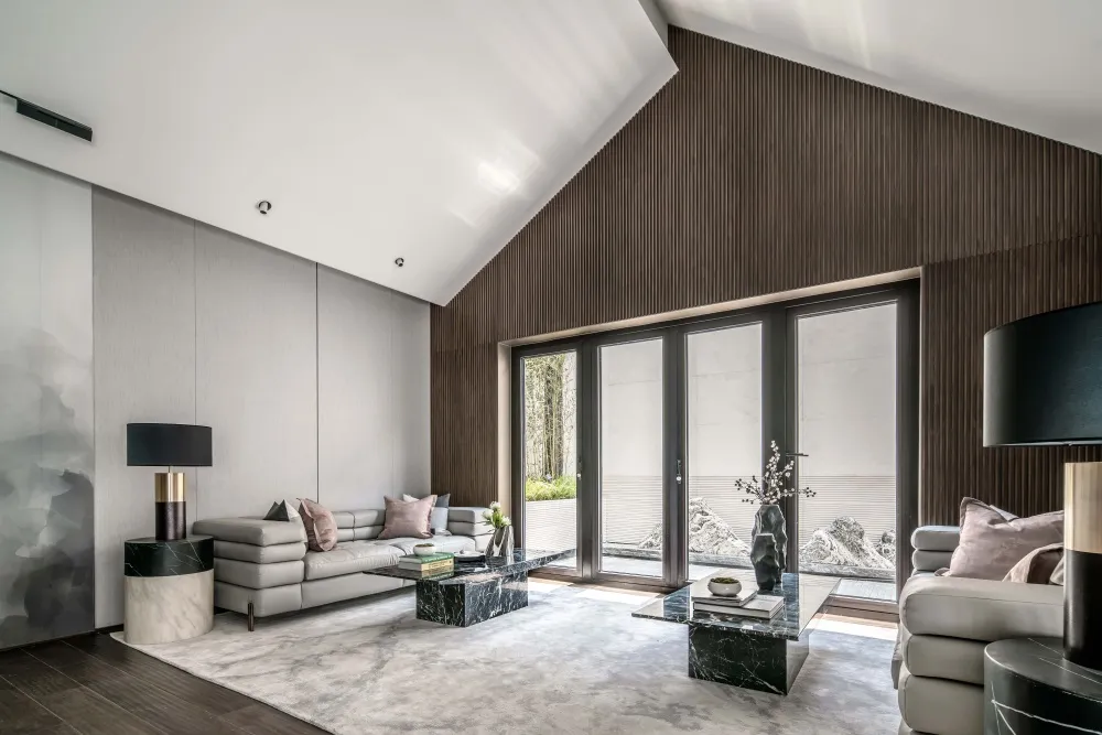 Modern living room featuring marble flooring, metallic furniture, and wood-paneled walls.