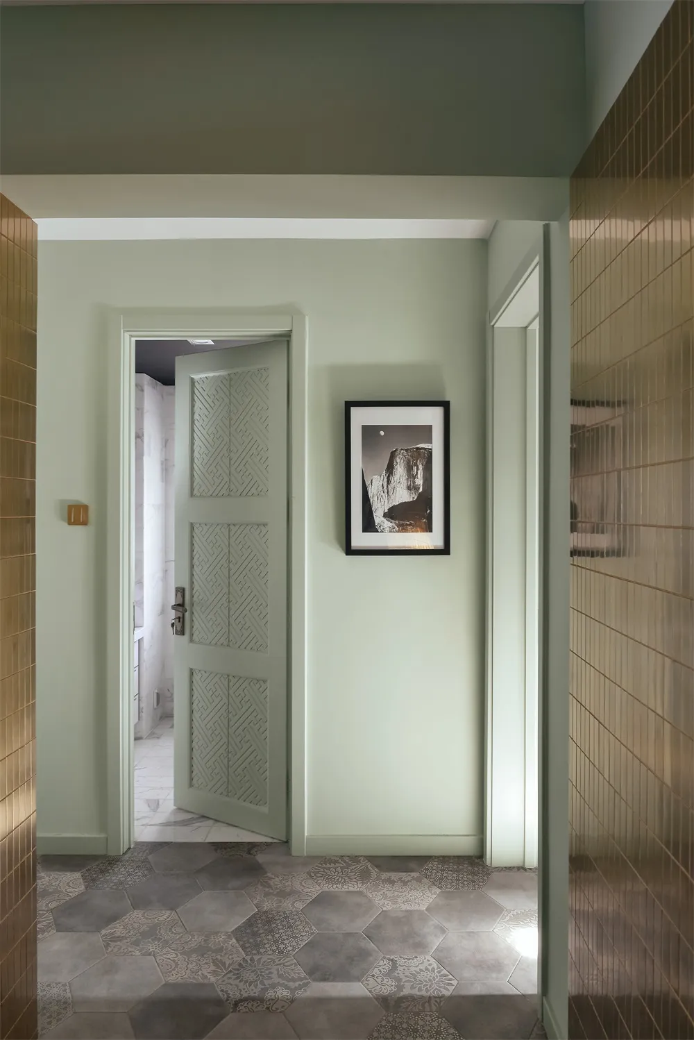 A corridor featuring patterned tiles and minimalist decor.