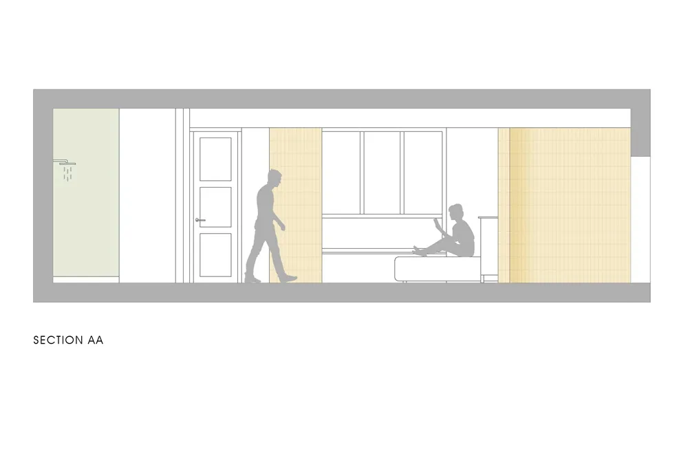 Minimalist bedroom section with a person sitting on a bed and another walking by, featuring light-colored walls and a bed wit