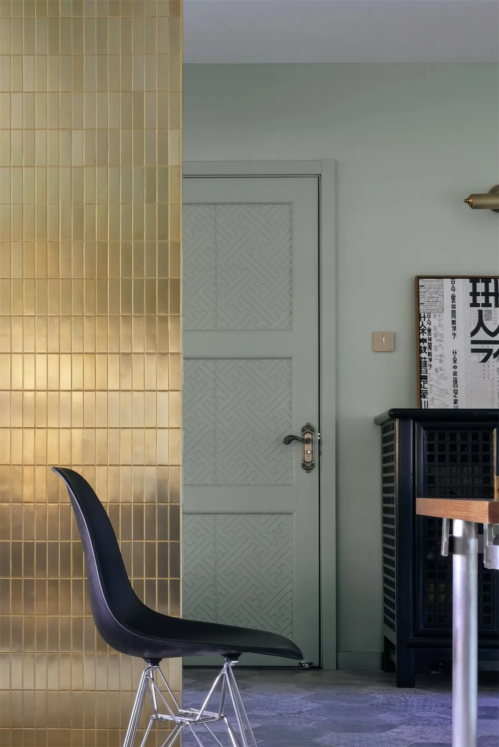 Modern entryway featuring metallic tile flooring and a green door.