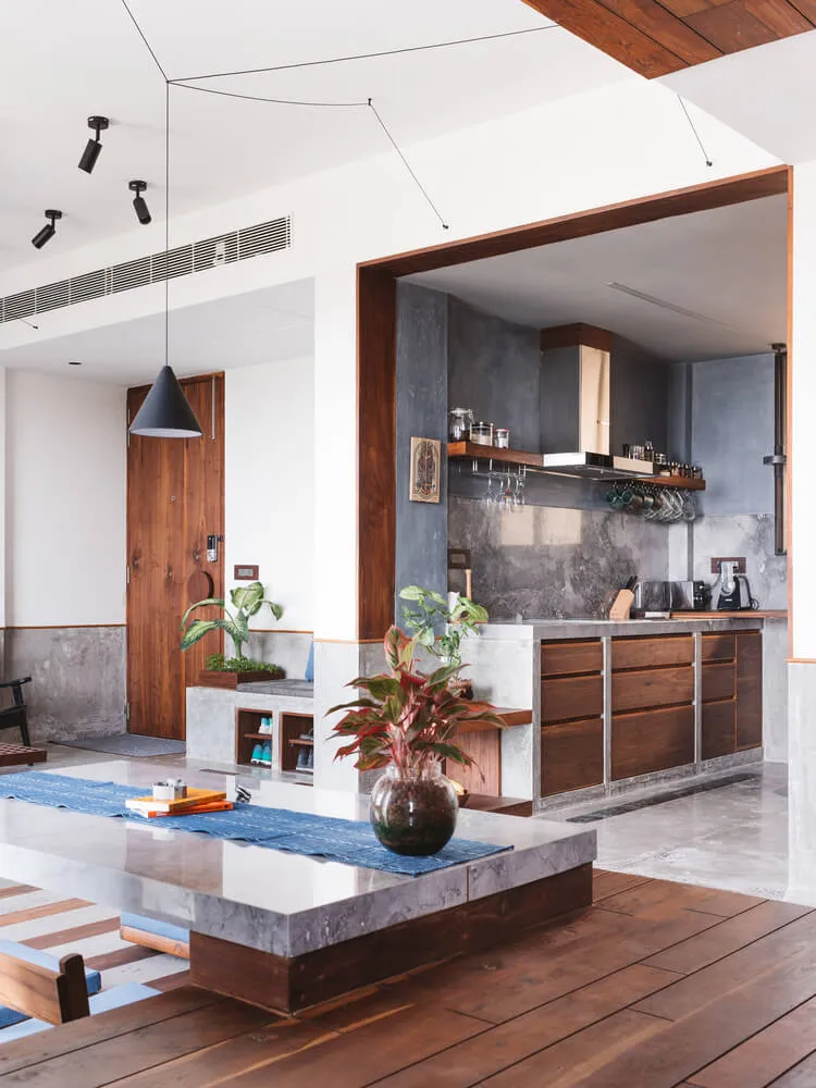 Contemporary residential kitchen featuring concrete countertops and wooden cabinets.