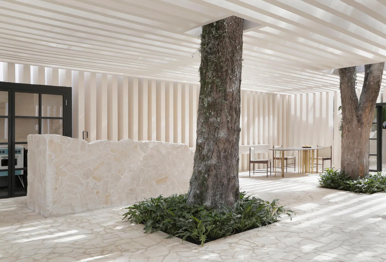 Modern minimalistic living room with concrete floor and natural stone accents