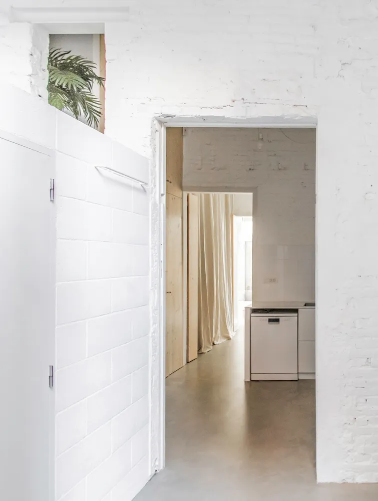 Modern kitchen featuring minimalist design and concrete surfaces.