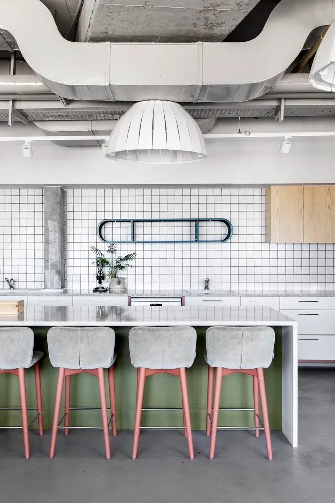 Modern coffee shop with industrial elements, concrete floor, cement tiles, and steel accents.