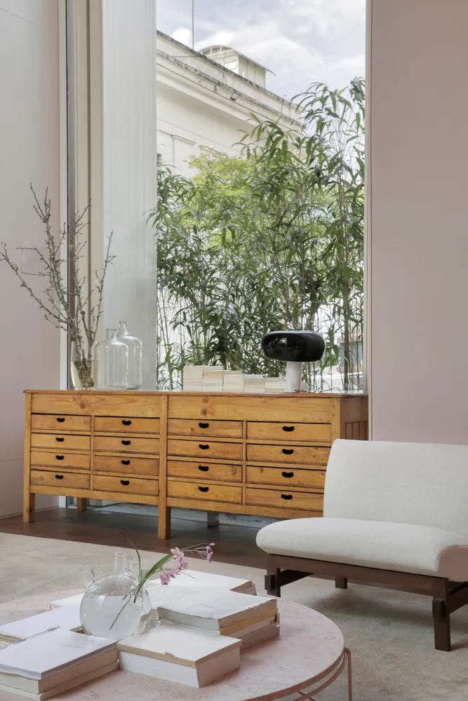 Modern living room with wooden drawer furniture and large window