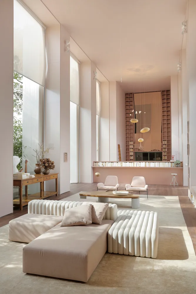 Modern minimalist living room featuring white materials and furniture.