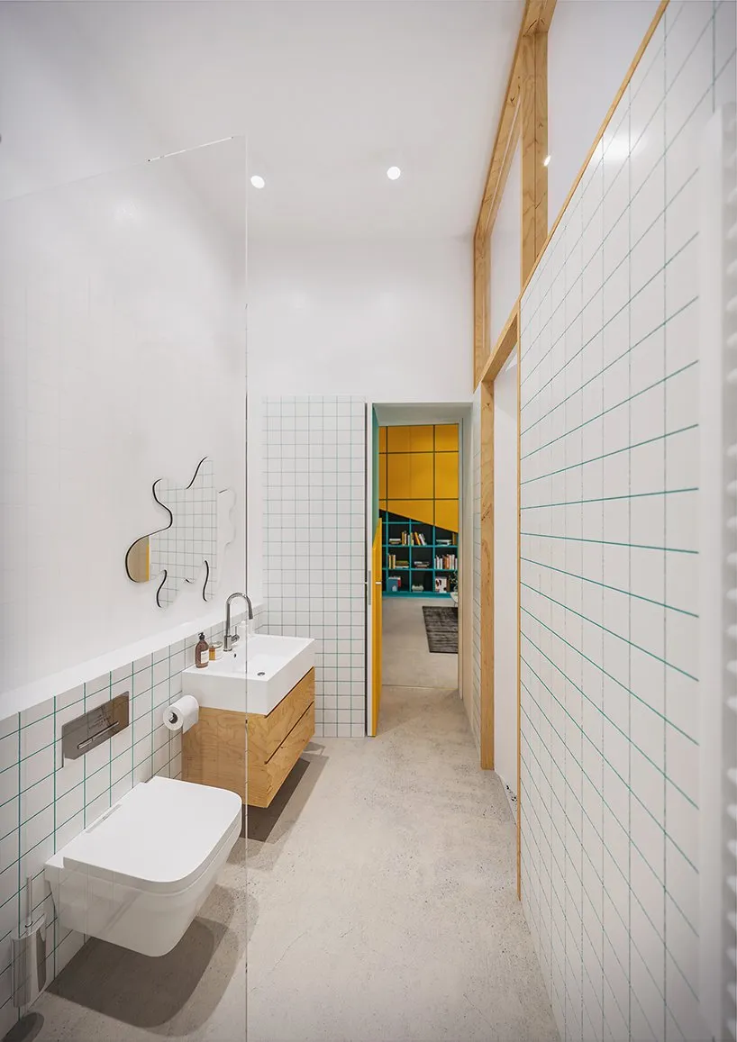 A minimalist bathroom featuring white tiles with a grid pattern and wooden fixtures.