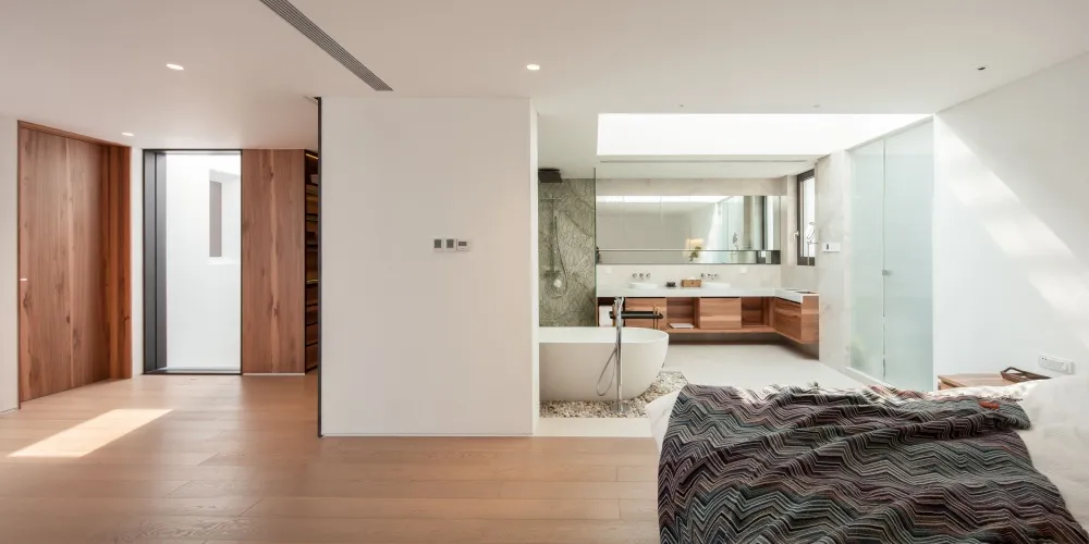Modern residential interior with wooden floors and a minimalist bathroom design.