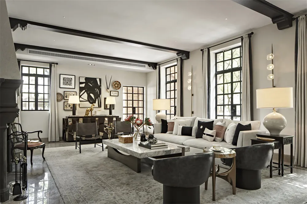 A modern living room featuring a marble coffee table and leather chairs.