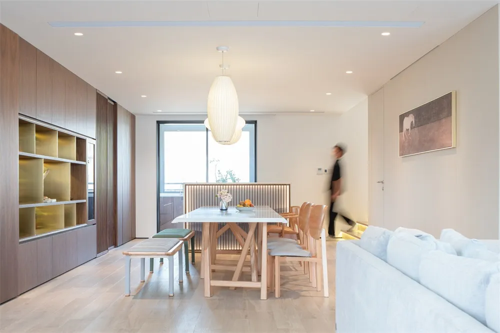 Modern residential space featuring wood, glass, and white materials.