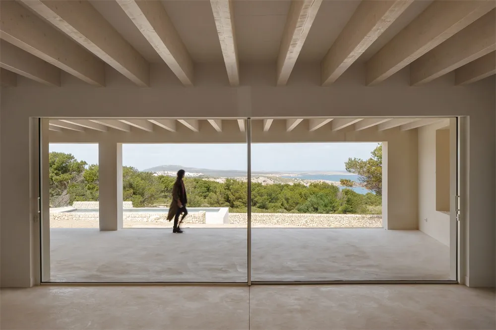 Interior design featuring concrete walls and floor, minimalist aesthetic.