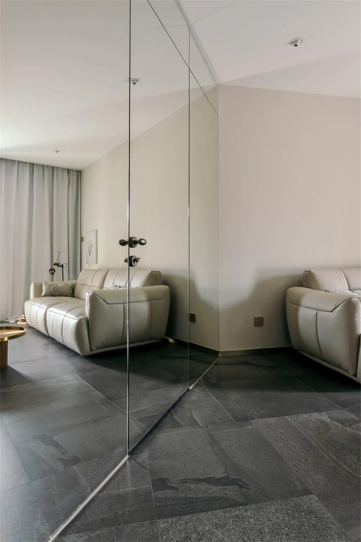 Modern living room featuring leather sofas, minimalist design, and sleek furniture.