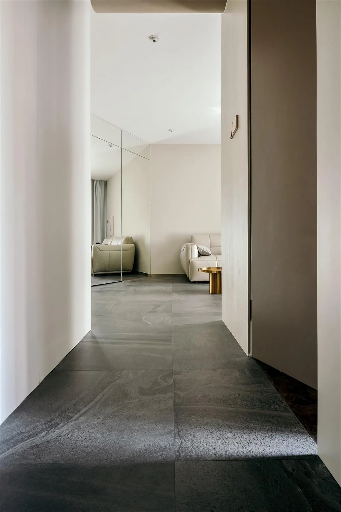 A modern living room featuring sleek, minimalist design with concrete tiles flooring.