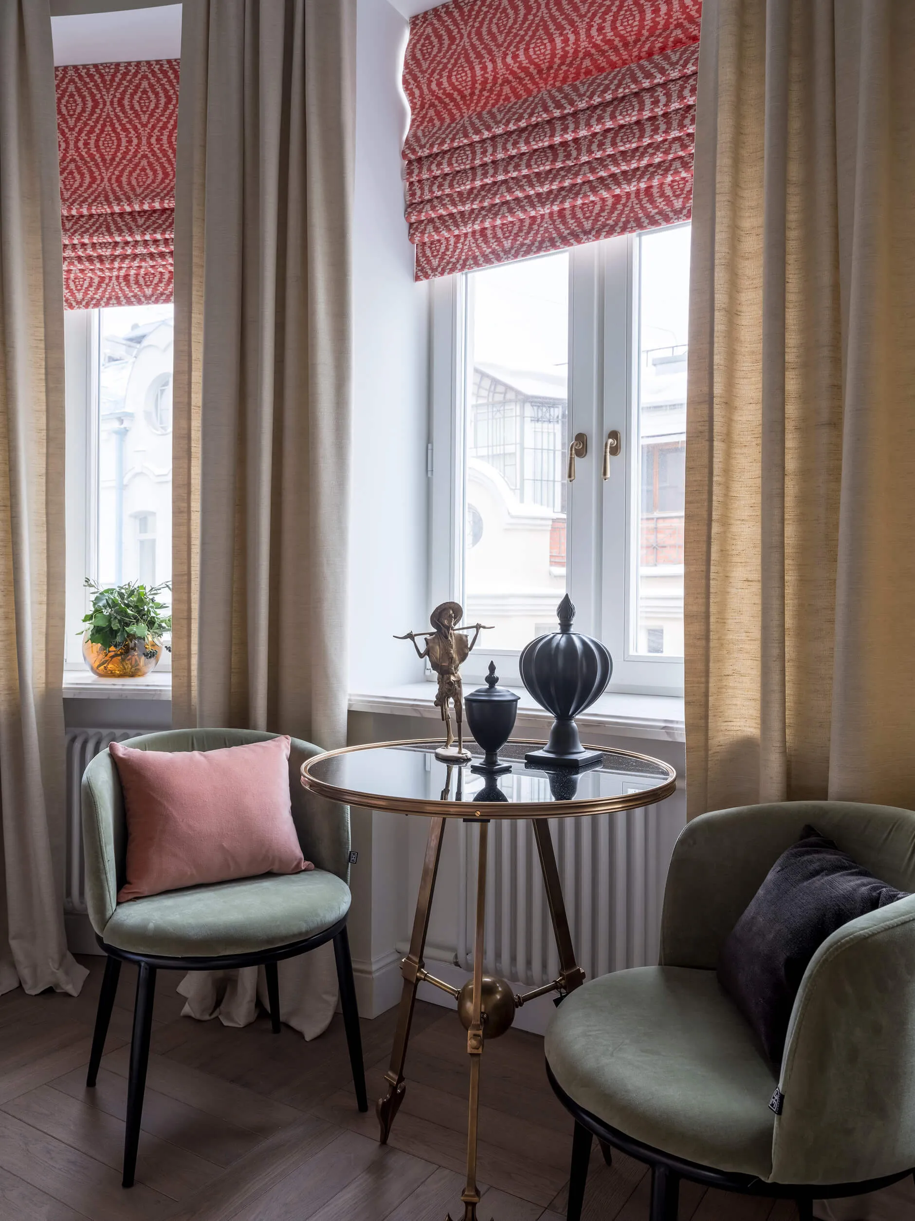 A modern lounge room featuring curtains within a window, including decorative elements and seating.