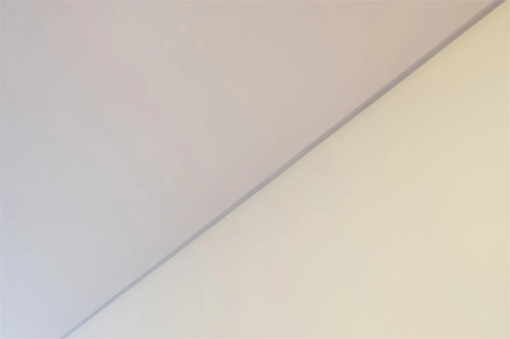 A minimalist interior with a white wall.