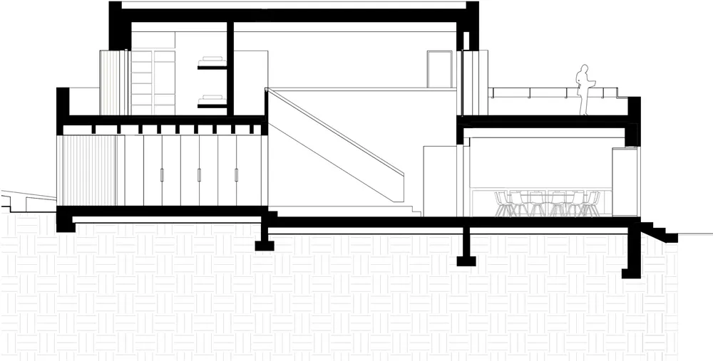 A detailed architectural floor plan in monochrome, showing a two-story residential building with a staircase leading to an up