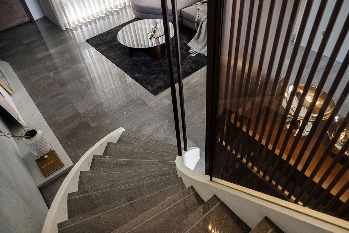 A minimalist interior staircase with wooden railings and marble steps.