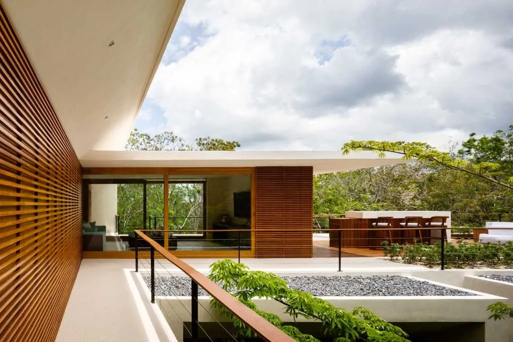Modern residential exterior showcasing wooden accents and stone elements.