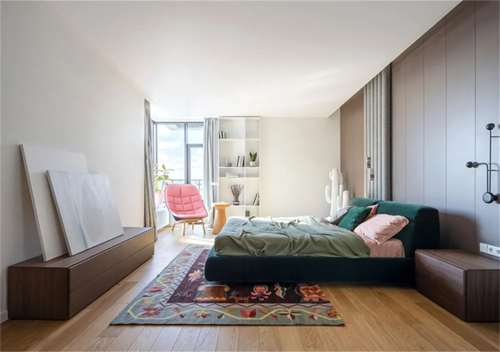 Minimalist bedroom with wooden furniture, carpet flooring, and fabric bedding.