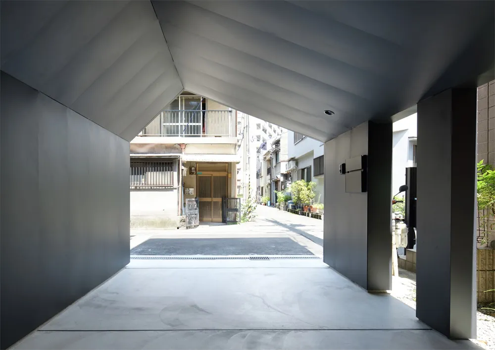 An urban entrance way featuring modern, minimalist architectural design elements.