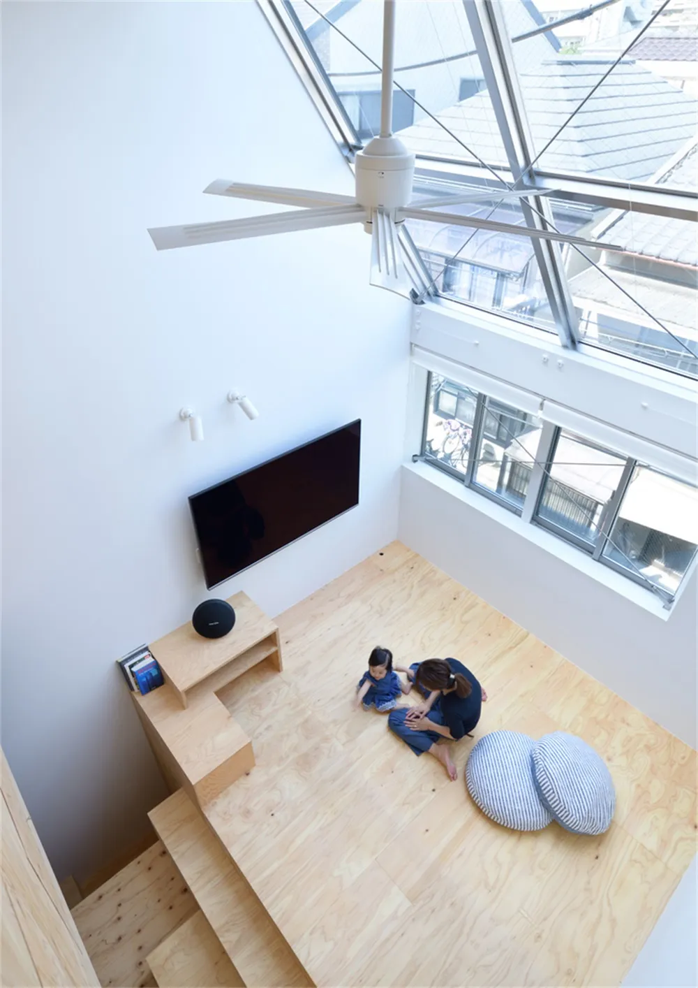 A modern living room with a wooden floor and a large window