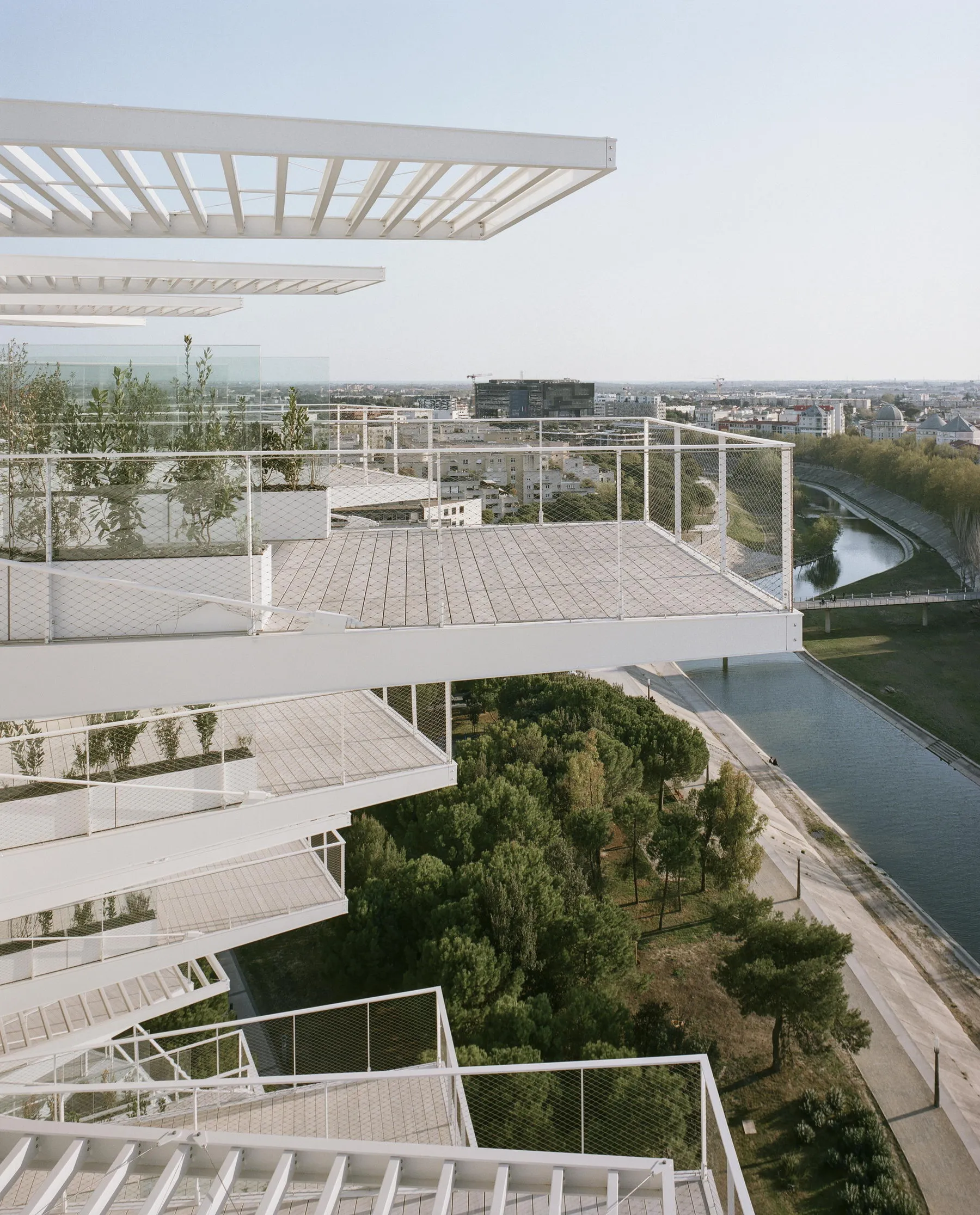 A parking lot featuring modern architectural elements such as timber and glass.