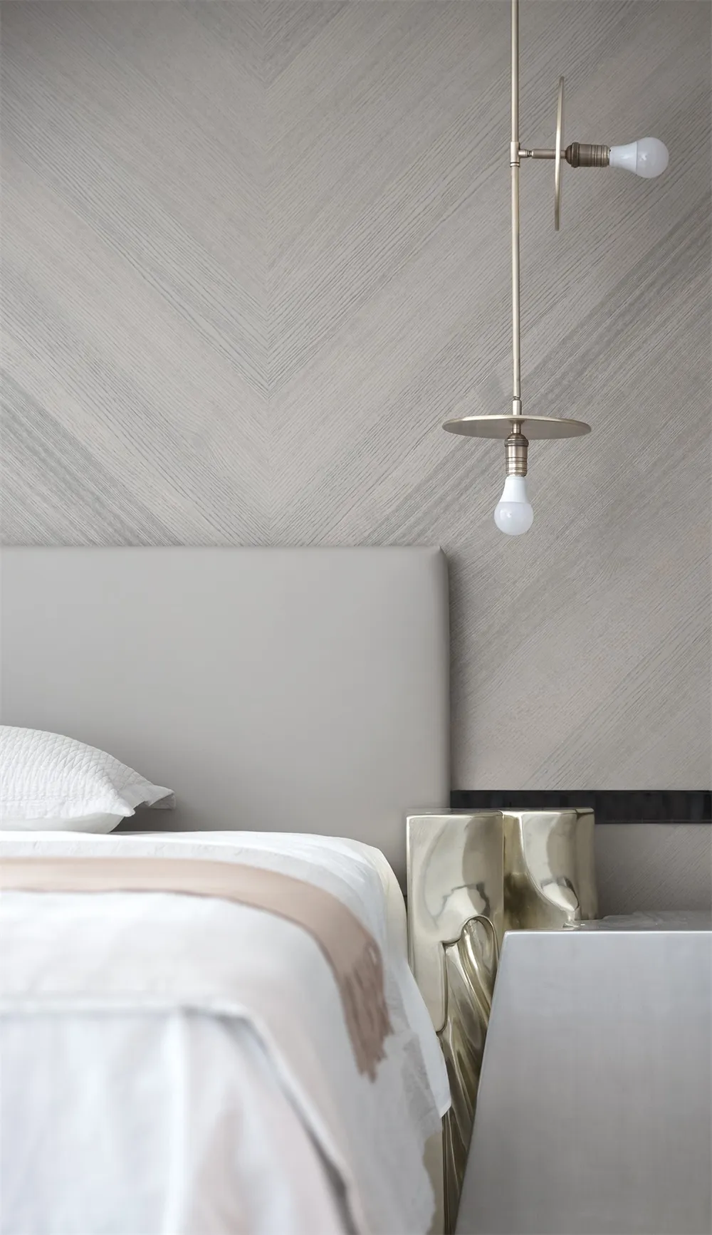 Modern, minimalist bedroom featuring a bed with metallic headboard and metallic side tables.