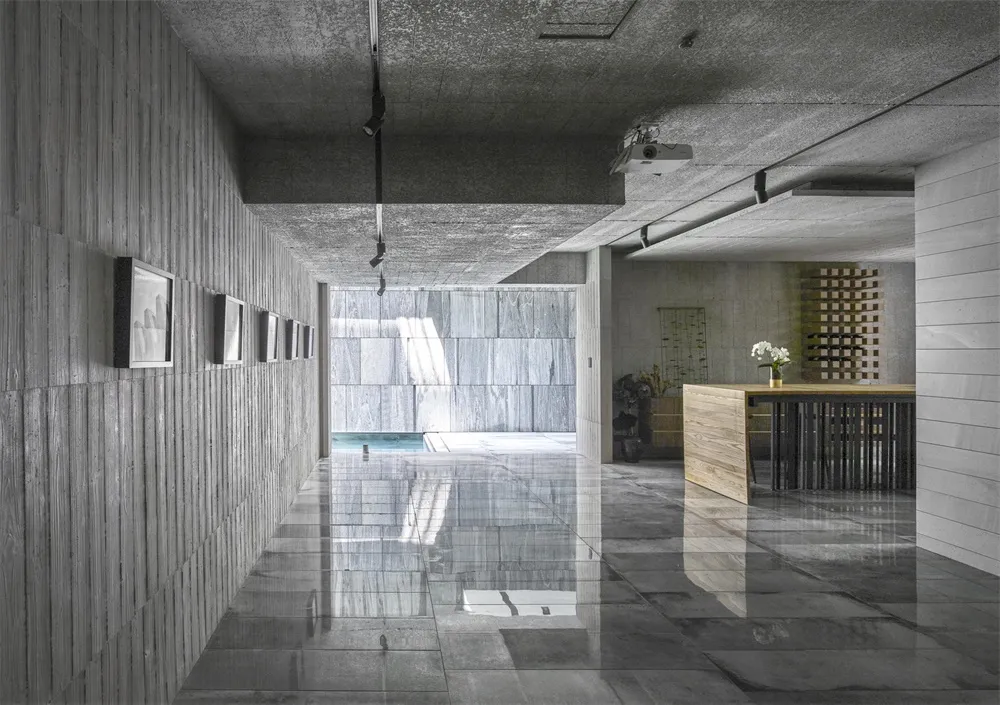 A modern minimalist building with a concrete exterior and geometric design features.
