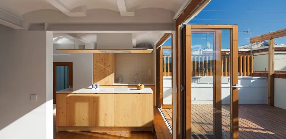 A modern residential kitchen with wood finishes.