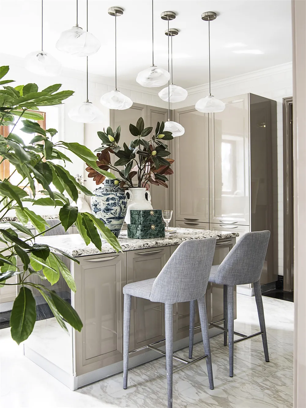 A minimalist residential kitchen featuring marble and glass elements.
