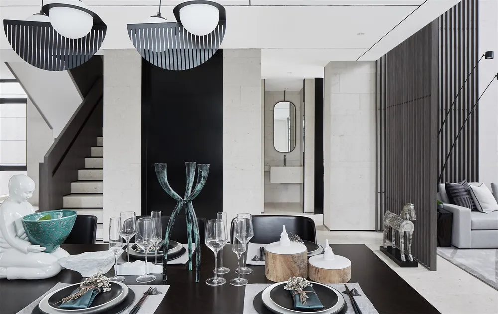 Modern interior design of a dining room with minimalist decor, dark wood table, white and black marble wall, and contemporary