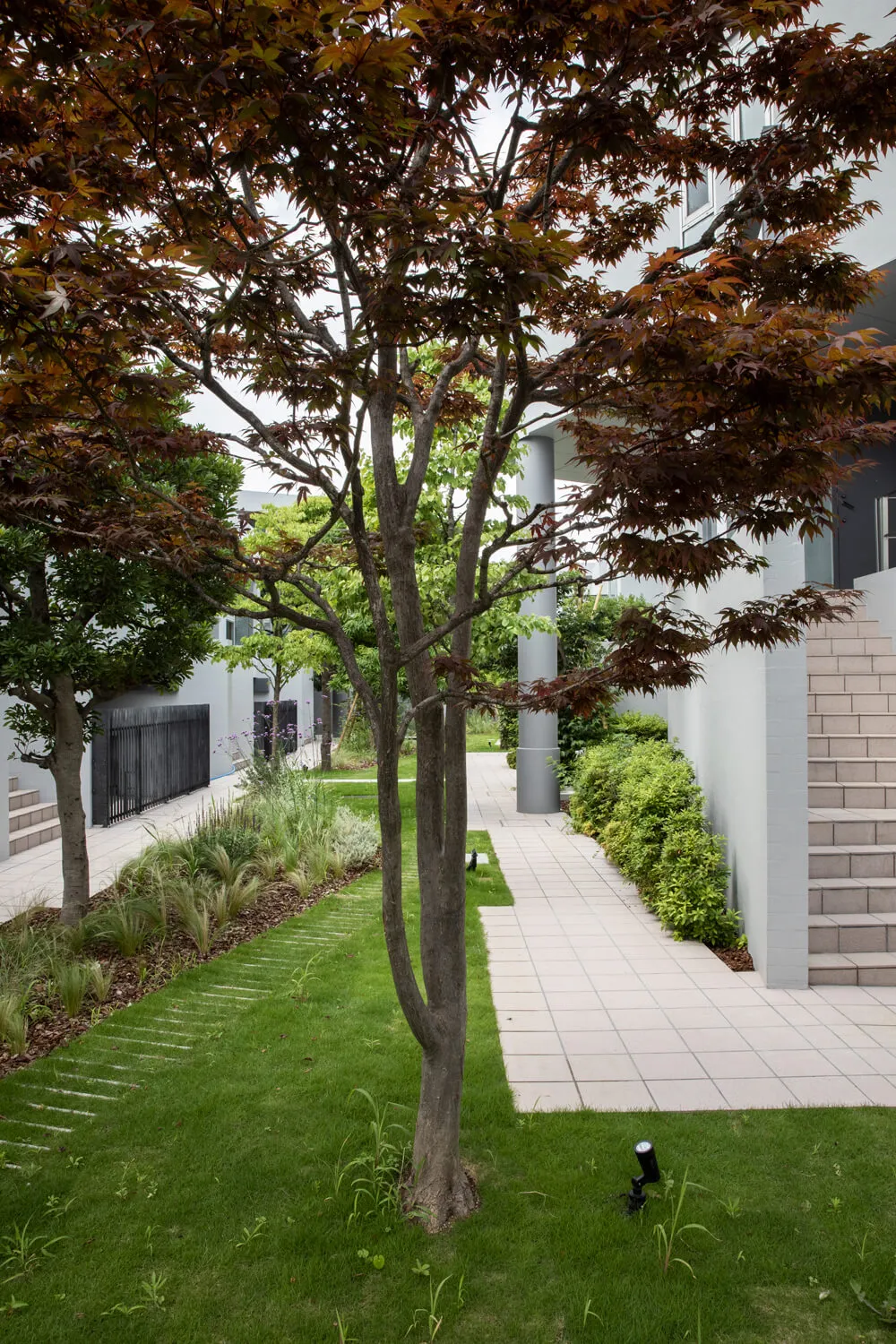 A modern residential entrance featuring natural materials such as stone and wood.
