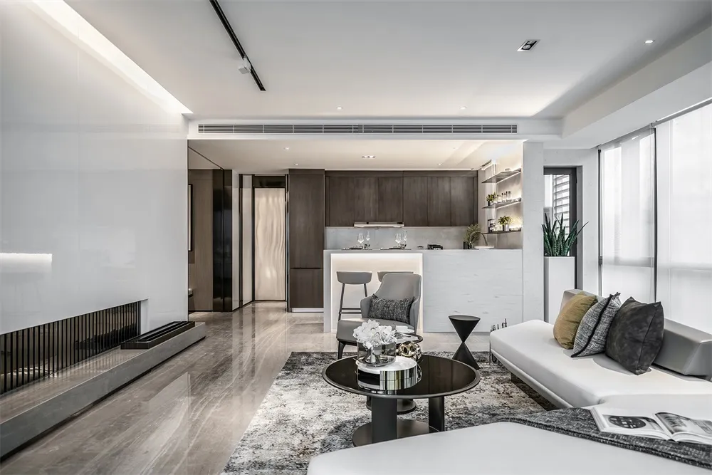 Modern living room with white and gray furniture, marble floor, and minimalist decor.