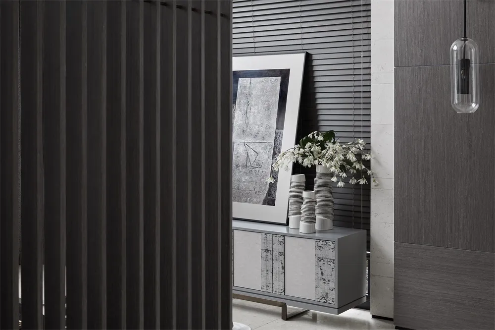 A modern living room featuring metallic furniture and abstract art.