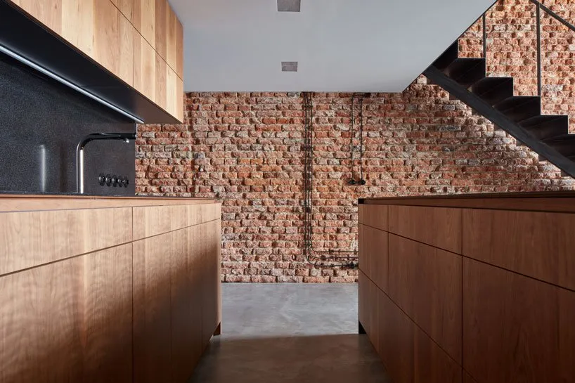 Industrial-style kitchen with reclaimed wood cabinets in a spacious, open-plan layout.