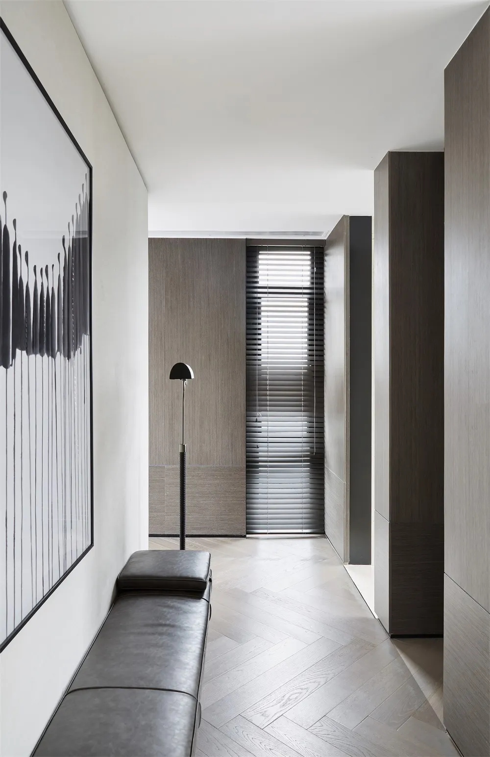 Modern interior corridor with wooden flooring and minimalist design elements.