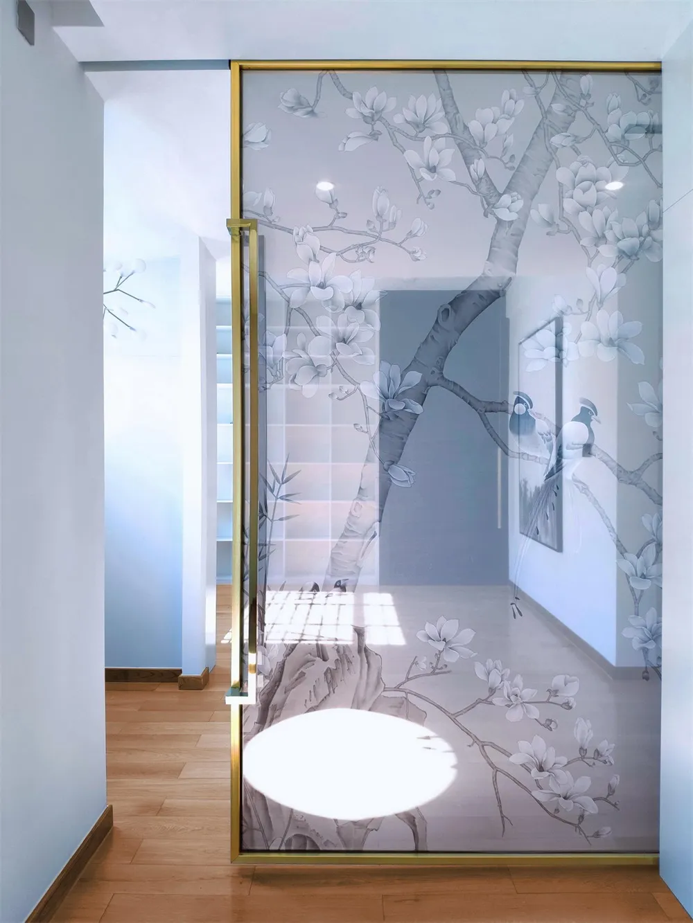 A modern interior design featuring a glass door with an ephemeral flower pattern.