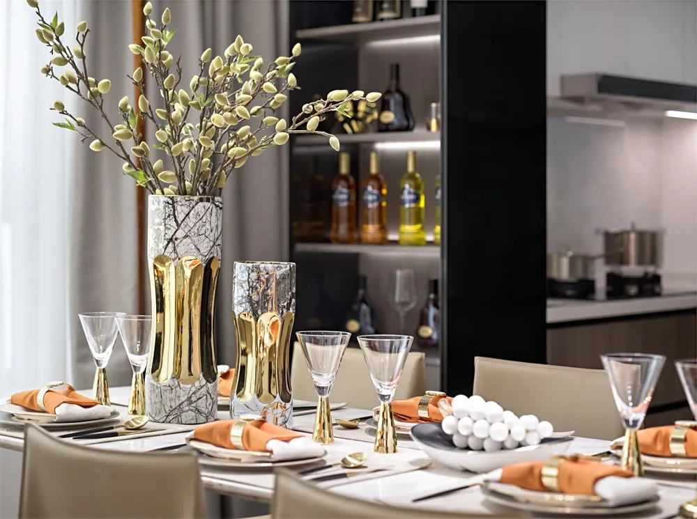 A modern dining room featuring marble and glass elements.
