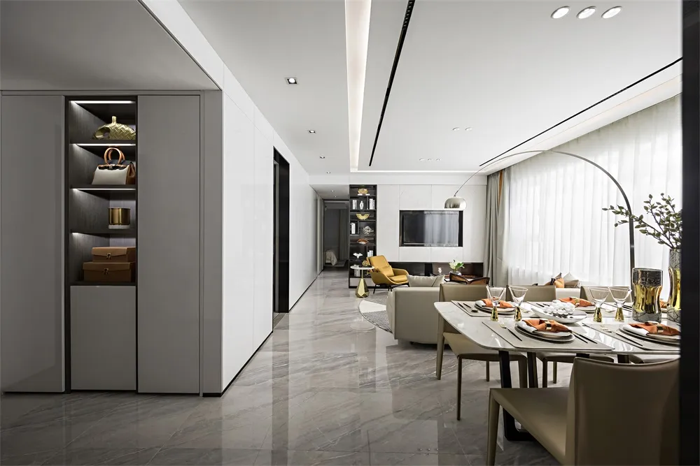 Modern living and dining room featuring marble flooring, glass and metal furniture, and a large window.