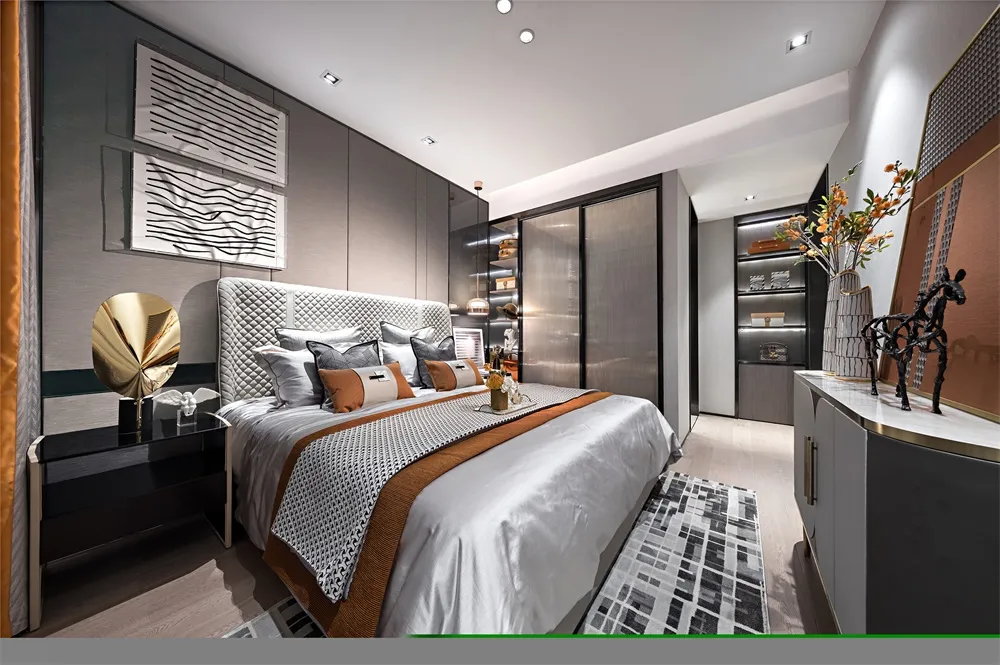 A modern bedroom showcasing fabric bedding, metallic accents, and glass elements.