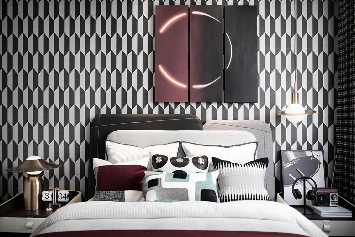A modern bedroom with fabric headboard, metal accents, and wood elements.