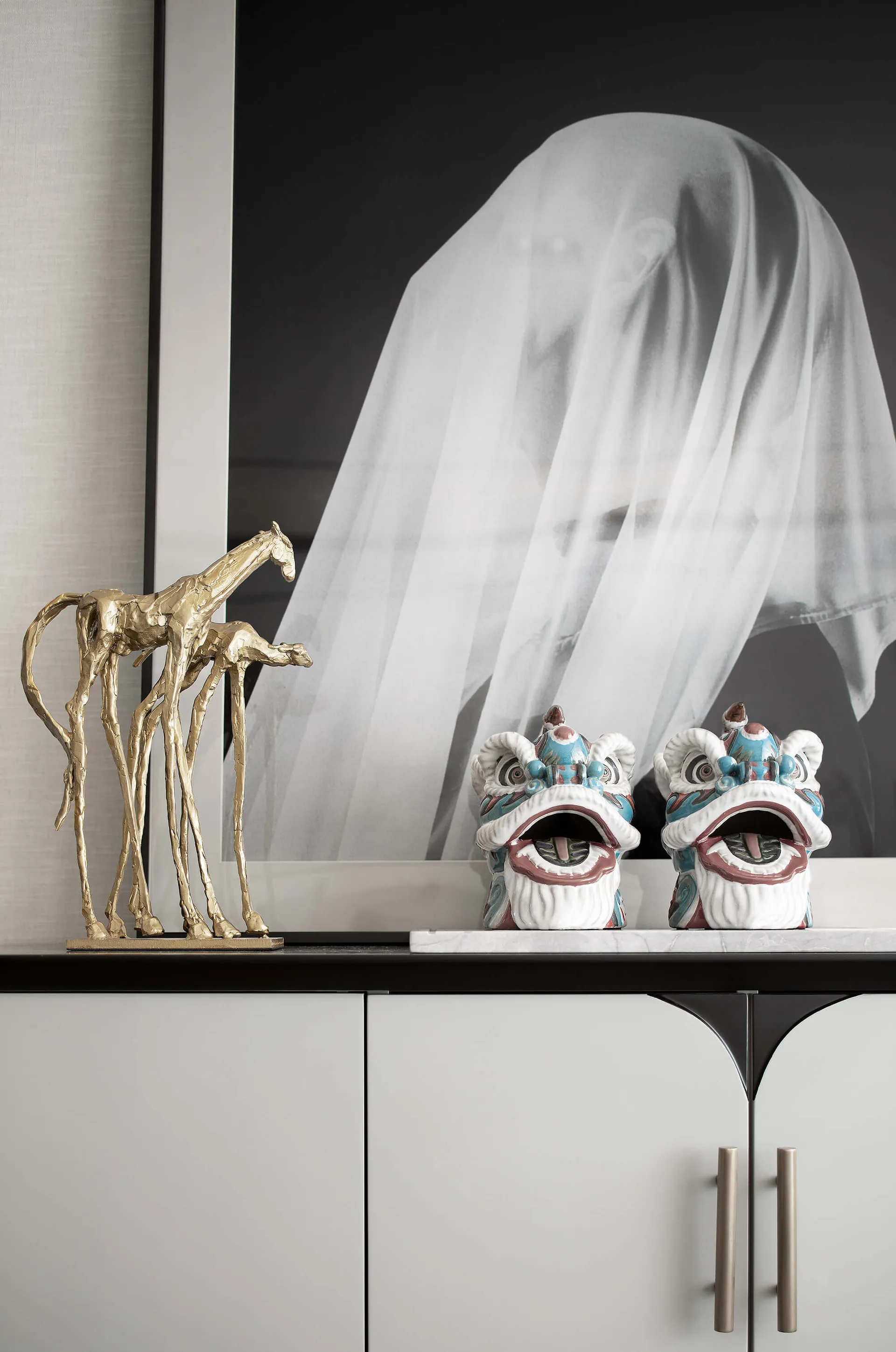 A modern interior featuring decorative marble, ceramic, and metallic objects.