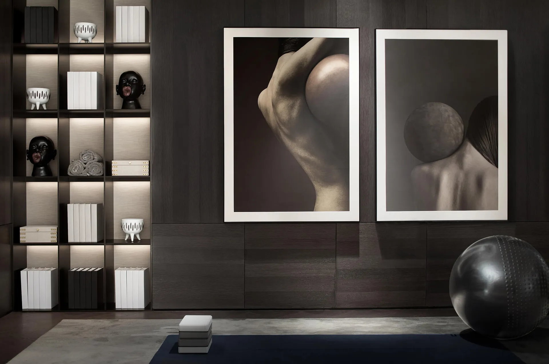 A modern yoga studio featuring wooden furnishings and abstract artwork.