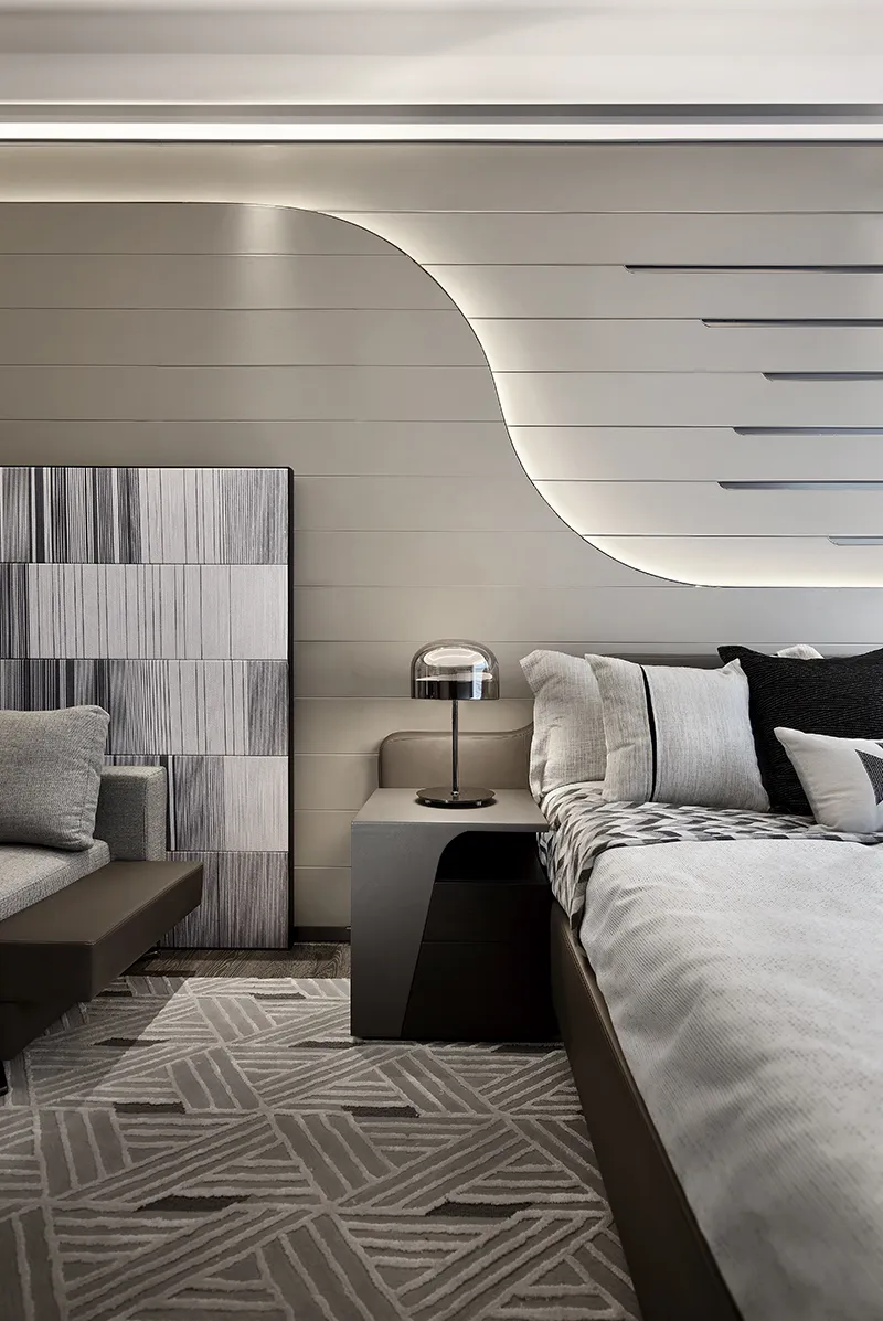 Modern bedroom featuring a textured wall design and minimalist decor.