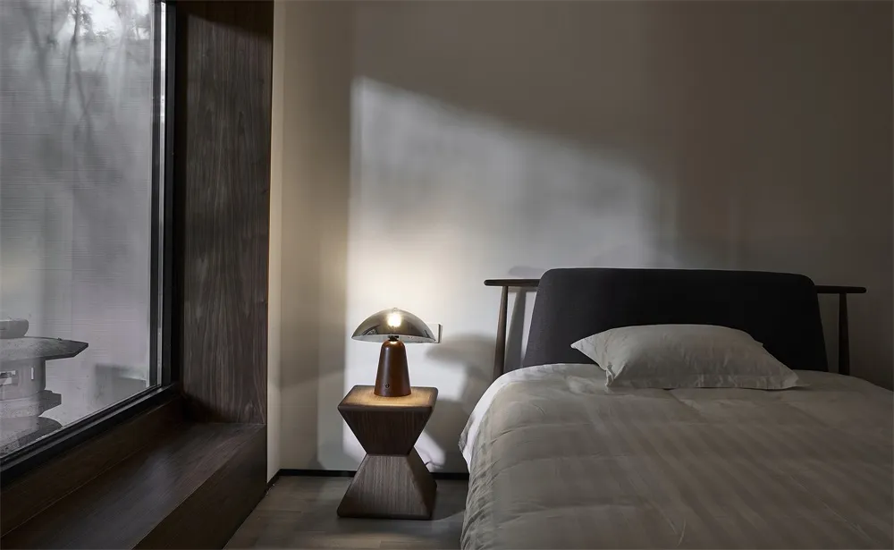 Minimalist bedroom with a upholstered bed, wooden headboard, and white bedding.
