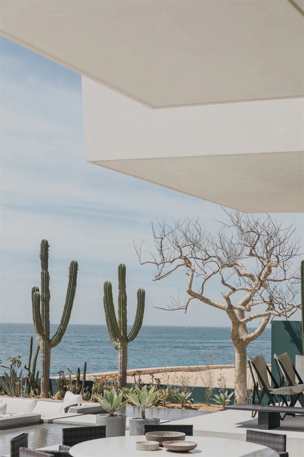 Concrete patio overlooking the ocean with a modern architectural design.