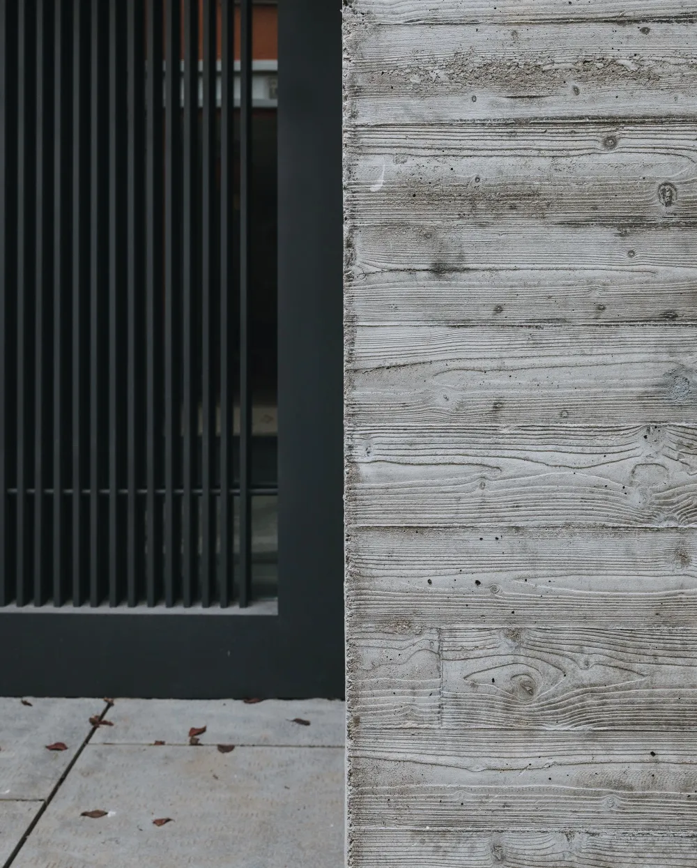 Modern minimalist building exterior featuring textured concrete panels