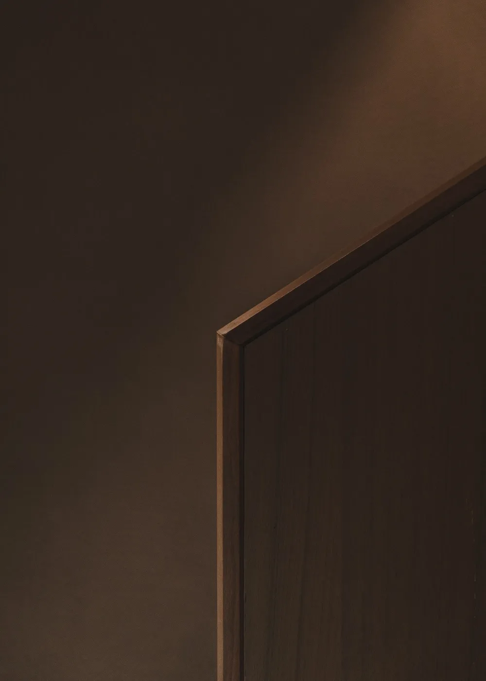 A minimalist door made of wood.