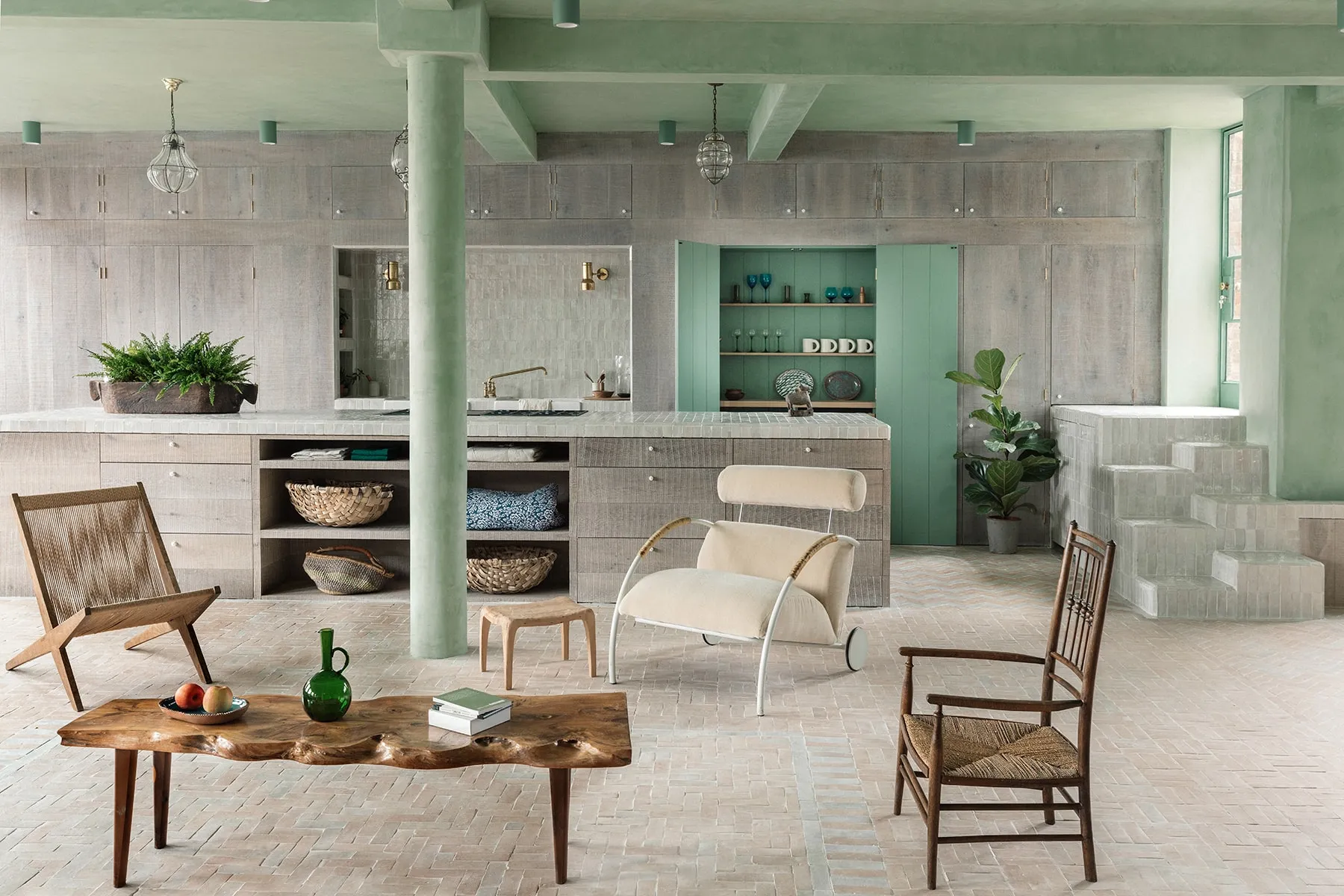 Modern industrial living room with wooden furniture, concrete floor, and green accents